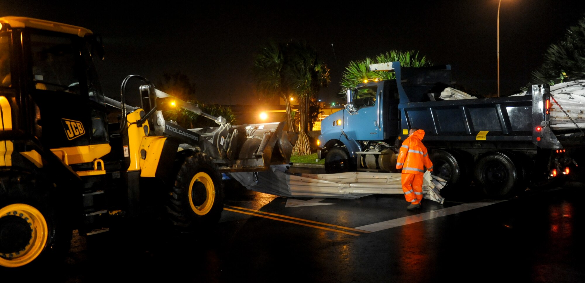 The 18th Civil Engineer Squadron members clear the street of fallen debris from Typhoon Jelawat on Kadena Air Base, Japan, Sept. 29, 2012. The typhoon battered the island with sustained winds of 85 mph causing several injuries on base and significant damage to base property. (U.S. Air Force photo/Airman 1st Class Justin Veazie)