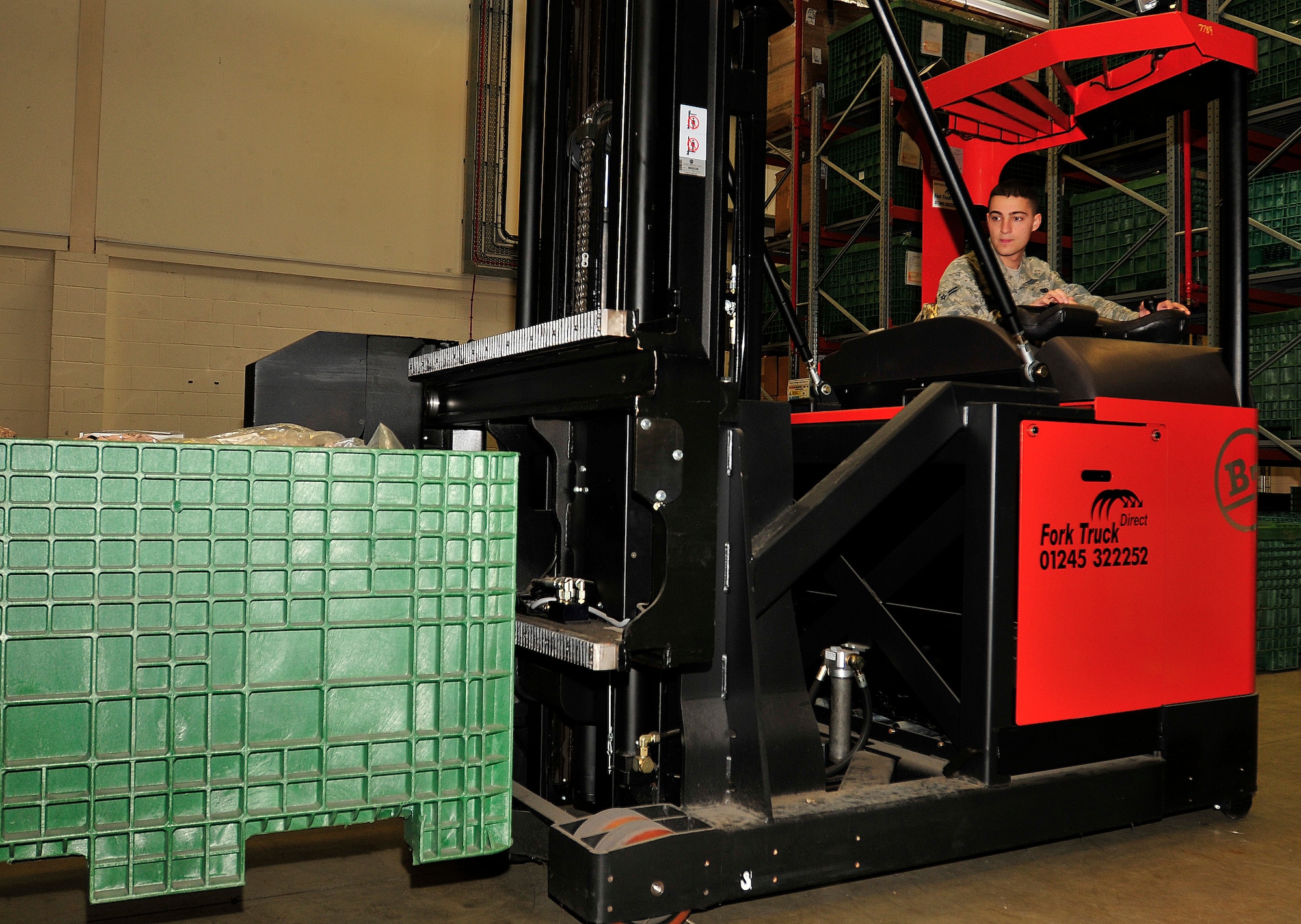 ROYAL AIR FORCE LAKENHEATH, England - Airman 1st Class Joshua Sprouse, 48th Logistics Readiness Squadron individual protective equipment journeyman, uses a forklift to move mobility gear in the Installation Deployment Readiness Center Sept. 27, 2012. Sprouse was nominated for a Liberty Spotlight because he displays the core value of "Excellence in All We Do." (U.S. Air Force photo by Senior Airman Tiffany M. Grigg)