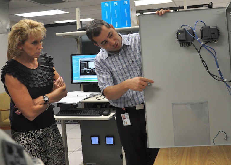 Dr. Christine Altendorf, USACE Headquarters Chief of Environmental Division, listens to John Bishop, a security engineer, as he explains a new system designed to support the metering of utilities on Fort Huachuca in Sierra Vista, Ariz., Aug. 29. Altendorf's visit to the post was part of a trip to see some of the District's sustainability initiatives and how they work under real-world conditions.