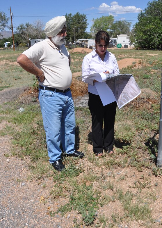 Fran Firouzi (right), a U.S. Army Corps of Engineers Los Angeles District project manager for Formerly Used Defense Sites, talks with Opjit Ghuman, Eco and Associates, about a site which may need to be cleaned of hazardous material just outside Kingman, Ariz. The District is working on a plan to contact residents about a Time Critical Removal Action for the sites in the area which was used as a skeet range when the area was part of the Kingman Ground-to Gound Gunnery Range during World War II. 