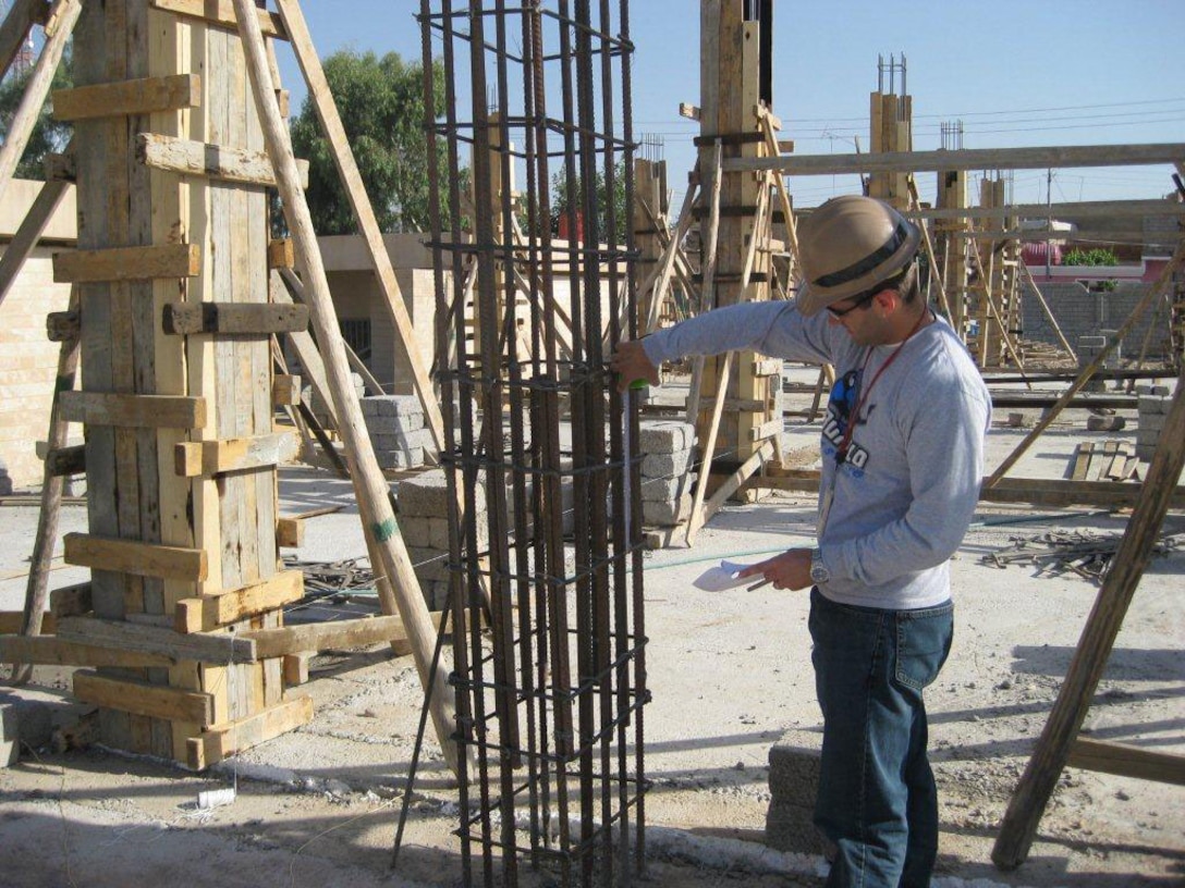 Adam Hamm, Civil/Structural Engineer with the U.S. Army Corps of Engineers Buffalo District, is conducting quality assurance by making sure the reinforcement for the concrete column has the correct spacing during the construction of the Al Dahkel elementary school in Dahuk, Iraq, Feb. 21, 2008. 