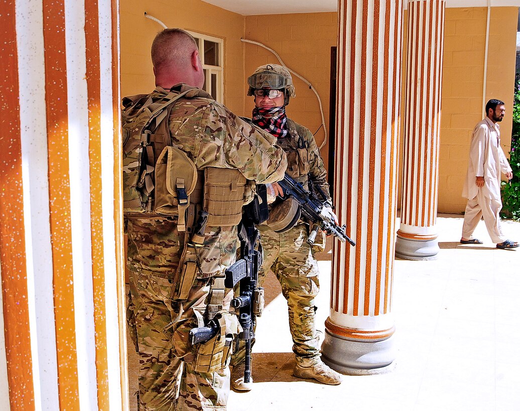 U.S. Army Lt. Col. Anthony Ulrich, left, discusses security with a member of his team in Farah City in Afghanistan's Farah province, Sept. 27, 2012. Ulrich, a civil affairs commander, is assigned to Provincial Reconstruction Team Farah.