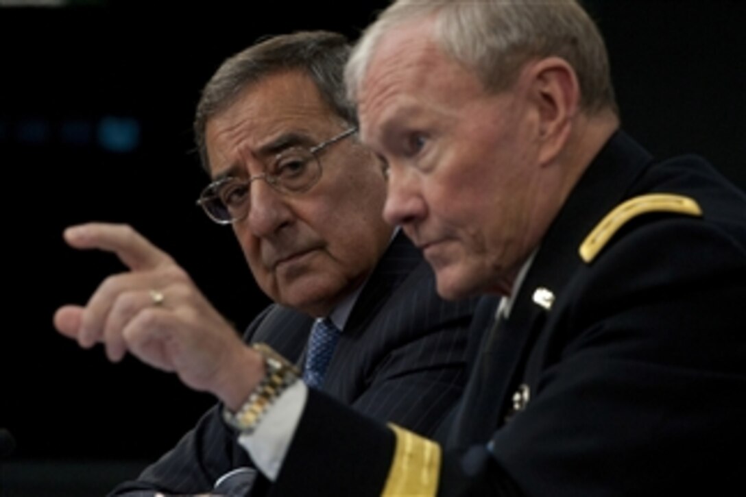 Secretary of Defense Leon E. Panetta listens as Chairman of the Joint Chiefs of Staff Gen. Martin E. Dempsey answers a reporter's question during a press briefing in the Pentagon on Sept. 25, 2012.  