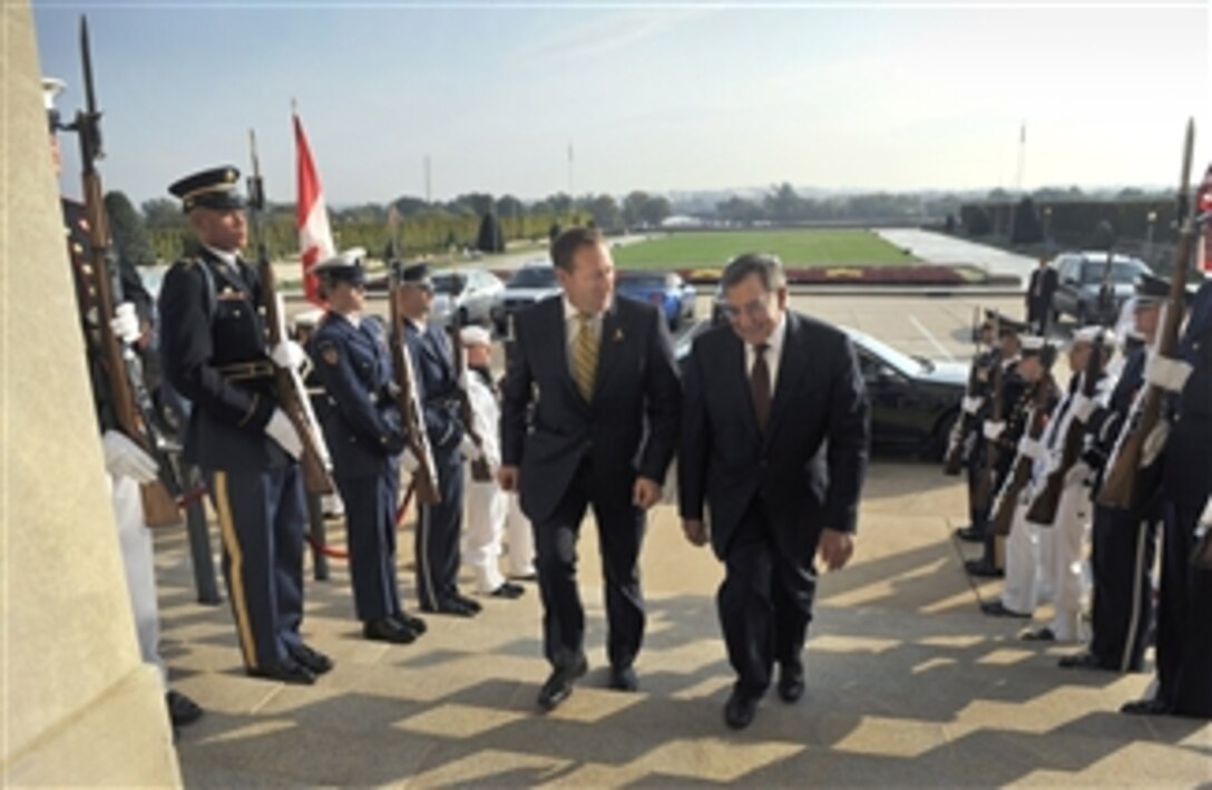 Secretary of Defense Leon E. Panetta, right, escorts Canadian Minister of National Defence Peter MacKay through an honor cordon and into the Pentagon on Sept. 28, 2012.  Panetta and MacKay will discuss national security items of interest to both nations.  