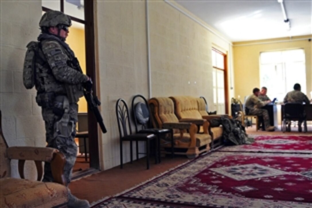 U.S. Army Staff Sgt. Paul Weber, left, provides security during a key leader engagement in Farah City in Afghanistan's Farah province, Sept. 27, 2012. Weber is assigned to Provincial Reconstruction Team Farah.