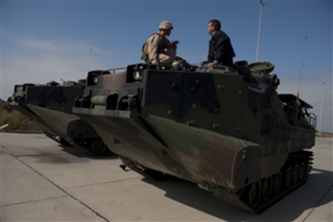 Deputy Secretary of Defense Ashton B. Carter, right, speaks with U.S. Marine Corps Staff Sgt. Michael Burkheart atop an amphibious assault vehicle at Camp Pendleton, Calif., on Sept. 27, 2012.  Carter and Secretary of the Navy Ray Mabus visited the amphibious assault ship USS Makin Island (LHD 8) and units stationed at Camp Pendleton during their two-day visit to San Diego.  