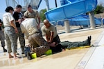 The emergency medical team from Fort Sam/Houston, Texas, rescues a dummy as part of the water extraction challenge during the Emergency Medical Technician Rodeo at Cannon Air Force Base, N.M., Sept. 21, 2012. The EMT Rodeo is a competition in which EMT teams from across the United States and Germany test their skills in various events that simulate real life scenarios. (U.S. Air Force photo/Airman 1st Class Xavier Lockley)