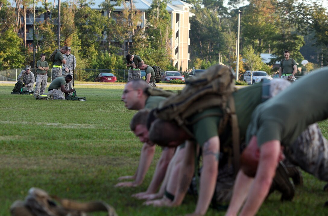Marines with Combat Logistics Battalion 6, 2nd Marine Logistics Group “build a house” during a physical training competition aboard Camp Lejeune, N.C., Sept. 27, 2012. The Marines had to stay in this position while the sixth teammate programmed a radio properly. 