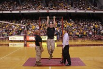 More than 5,000 people watch Recruiting Substation Bloomington's Staff Sgt. Ryan B. Simonis compete in a pull-up challenge at Williams Arena during a University of Minnesota volleyball match against Penn State on Sept. 29. Simonis and U of M wrestler Thane Antczak had 30 seconds to complete as many pull-ups as possible. Antczak, 22, from Prairie Farm, Wis., competed in the challenge even though he just finished a strength and conditioning workout with the wrestling team a few hours prior to the event. Simonis won the challenge by two repitions. For additional imagery from the event, visit www.facebook.com/rstwincities.   
