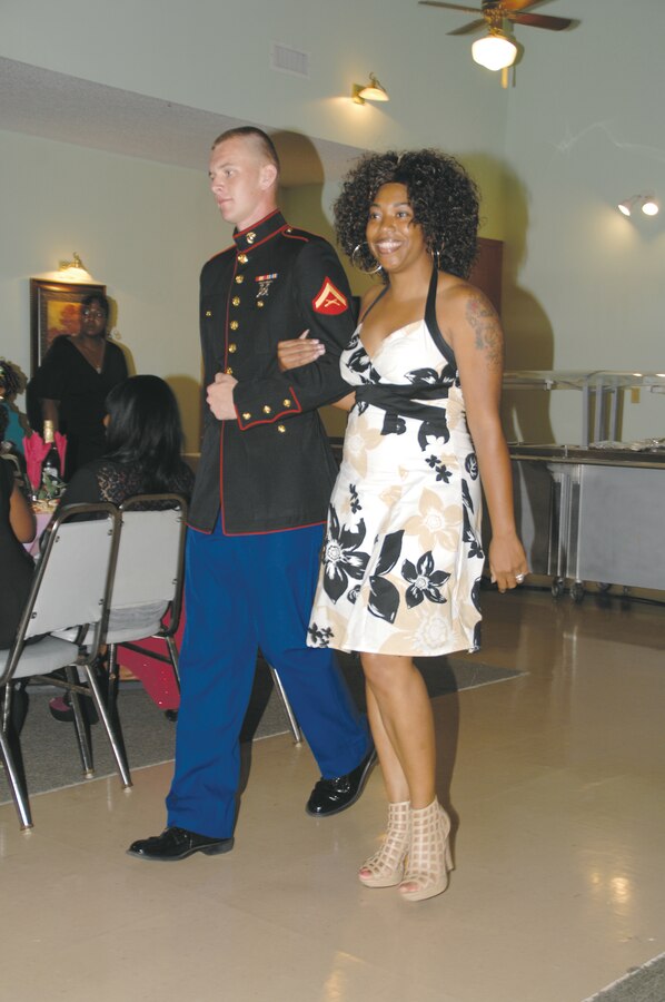 Lance Cpl. Lucas Thomas escorts a young lady to the red carpet at the first Divas’ Ball in Camilla, Ga., Sept. 8.
