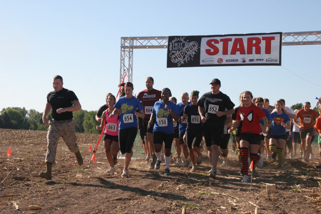 Staff Sgt. Peter Vargo, a recruiter based in Marinette, Wis., leads a group of runners kicking off the first ever Hot Mess Mud Run Sept. 15.