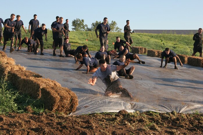 Recruiting Station Milwaukee Executive Officer Capt. Nicholas Borns leads a group of poolees on a pre-run of the Hot Mess Mud Run here Sept. 14. For more photos, visit: http://www.facebook.com/rsmilwaukee