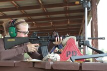 A poolee from Recruiting Substation Wausau, Recruiting Station Milwaukee, fires a rifle similar to the one she'll be issued in recruit training.