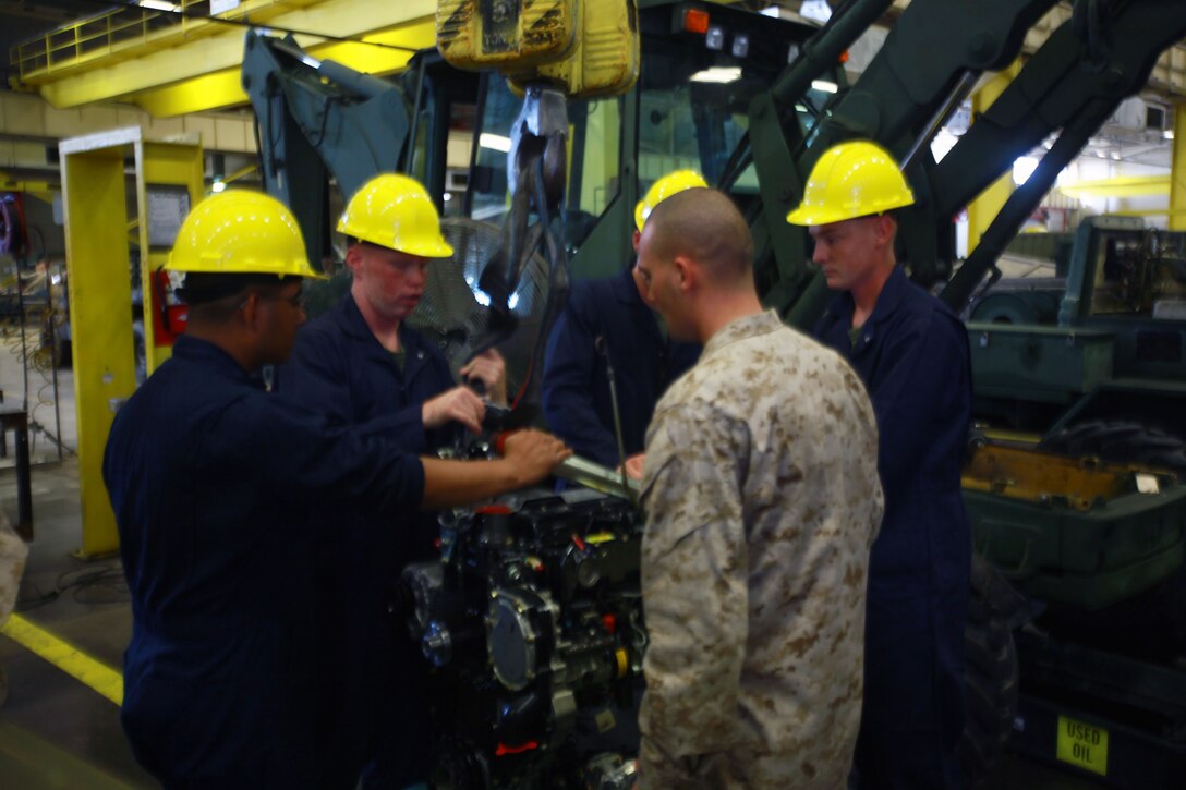 Marines with 2nd Maintenance Battalion, Combat Logistics Regiment 25, 2nd Marine Logistics Group discuss how to fix the engine during One Bullet Away Day aboard Camp Lejeune, N.C., Sept. 20, 2012.Tasks were handed down by noncommissioned officers who were chosen to take on leadership roles for the day. 