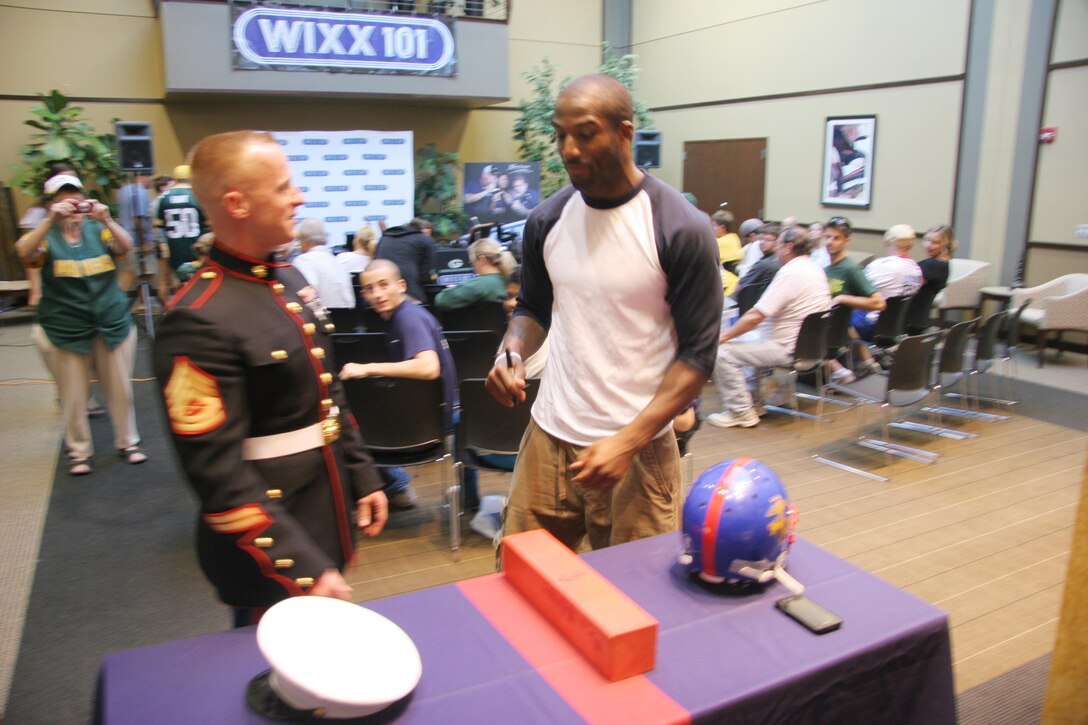 Gunnery Sgt. Matthew Voigtlander talks football with Green Bay Packers #24 Jarrett Bush Sept. 11.