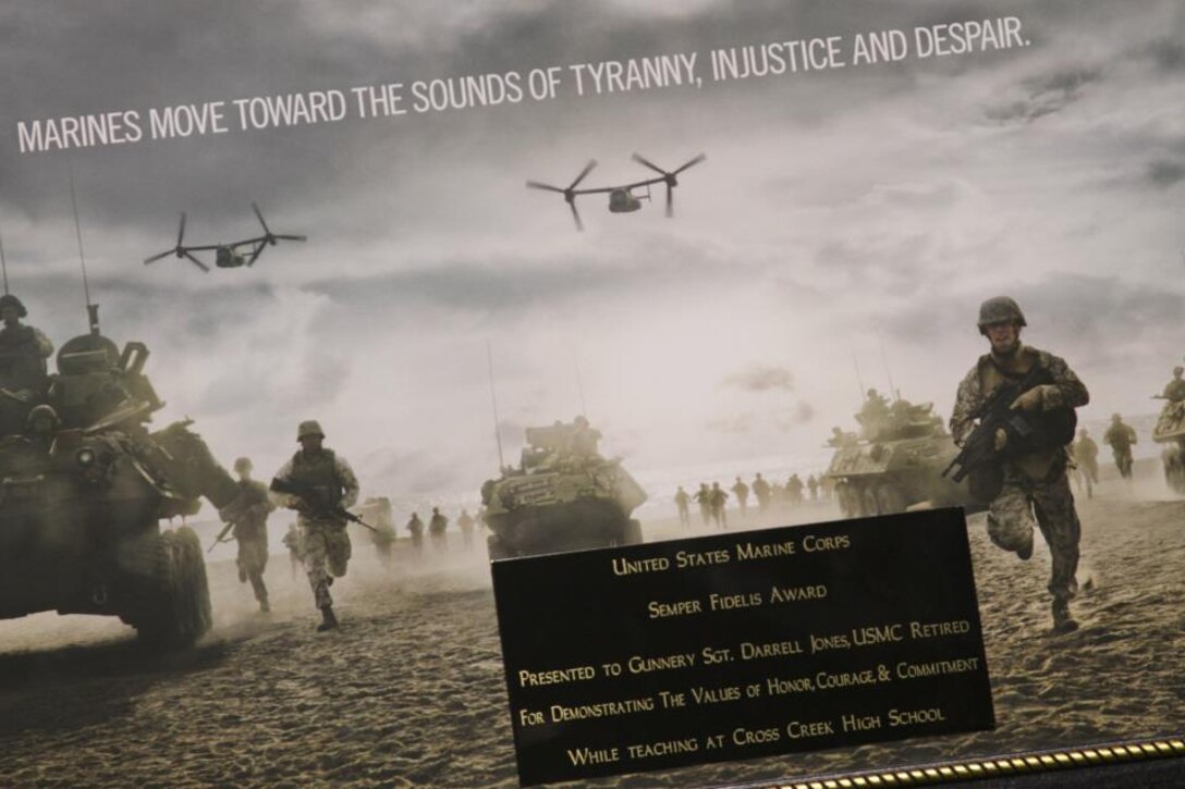 Sgt. Thomas Patterson, a canvassing recruiter with Recruiting Substation Augusta, Recruiting Station Columbia, presented the Semper Fidelis Award to Retired Gunnery Sgt. Darrell Jones Sept. 27 at Cross Creek High School in Augusta, Ga. The Cross Creek High School staff selected Jones for demonstrating the values of honor, courage, and commitment.