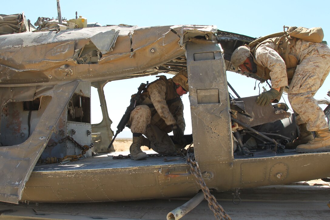 Marines with Marine Wing Support Squadron 171, of Iwakuni, Japan, look to recover a downed helicopter in the Combat Center’s Landing Zone Sand Hill training area Sept. 13, 2012.