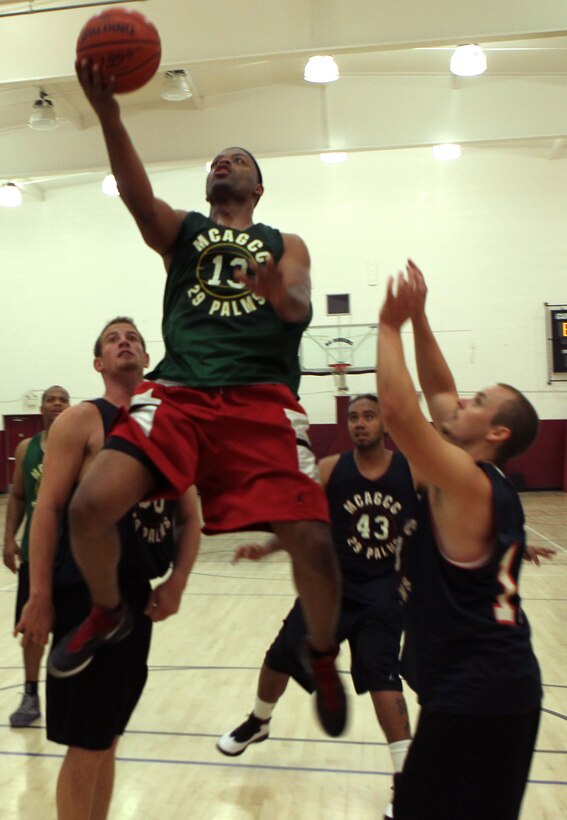 Old School’s Franco Robinson drives the ball to the hoop during the Basketball Slam Tournament Sept. 6. Too Tight beat Old School 76 - 71 during the final game of the month-long tournament.