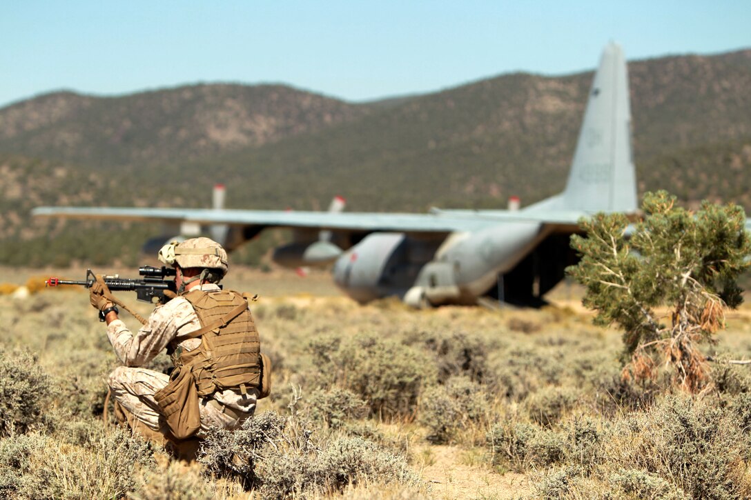 Cpl. James Coe, reconnaissance Marine, 2nd Reconnaissance Battalion, provides security for his fellow Marines after exiting a KC-130 at the Sweet Water training area, Marine Corps Mountain Warfare Training Center Bridgeport, Calif., Sept. 17, 2012.