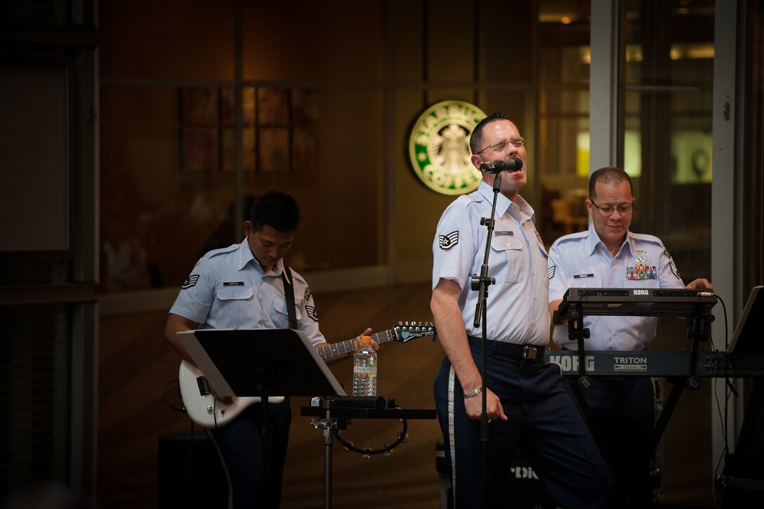 SAITAMA, Japan -- Staff Sgt. Geoff Fisher, center, Band of the Pacific-Asia vocalist, sings at the Saitama Super Arena Keyaki Square, Saitama, Japan on Oct. 2, 2012. Fisher and the two other lead vocalists took turns singing and harmonizing on the 10 songs Pacific Trends played. (U.S. Air Force photo/Staff Sgt. Josh Voyles)