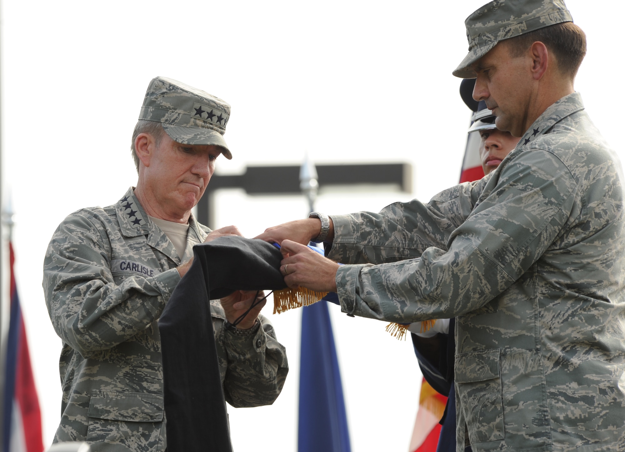 Gen. Herbert J. "Hawk" Carlisle, Pacific Air Forces commander, encases the 13th Air Force flag with Lt. Gen. Stanley T. Kresge, former 13th Air Force commander, during the 13th Air Force inactivation ceremony Sept. 28, 2012, at Joint Base Pearl Harbor-Hickam, Hawaii. The 13th Air Force was inactivated and combined with the staff of Pacific Air Forces at Joint Base Pearl Harbor-Hickam, Hawaii. (U.S. Air Force photo/Tech. Sgt. Matthew McGovern)