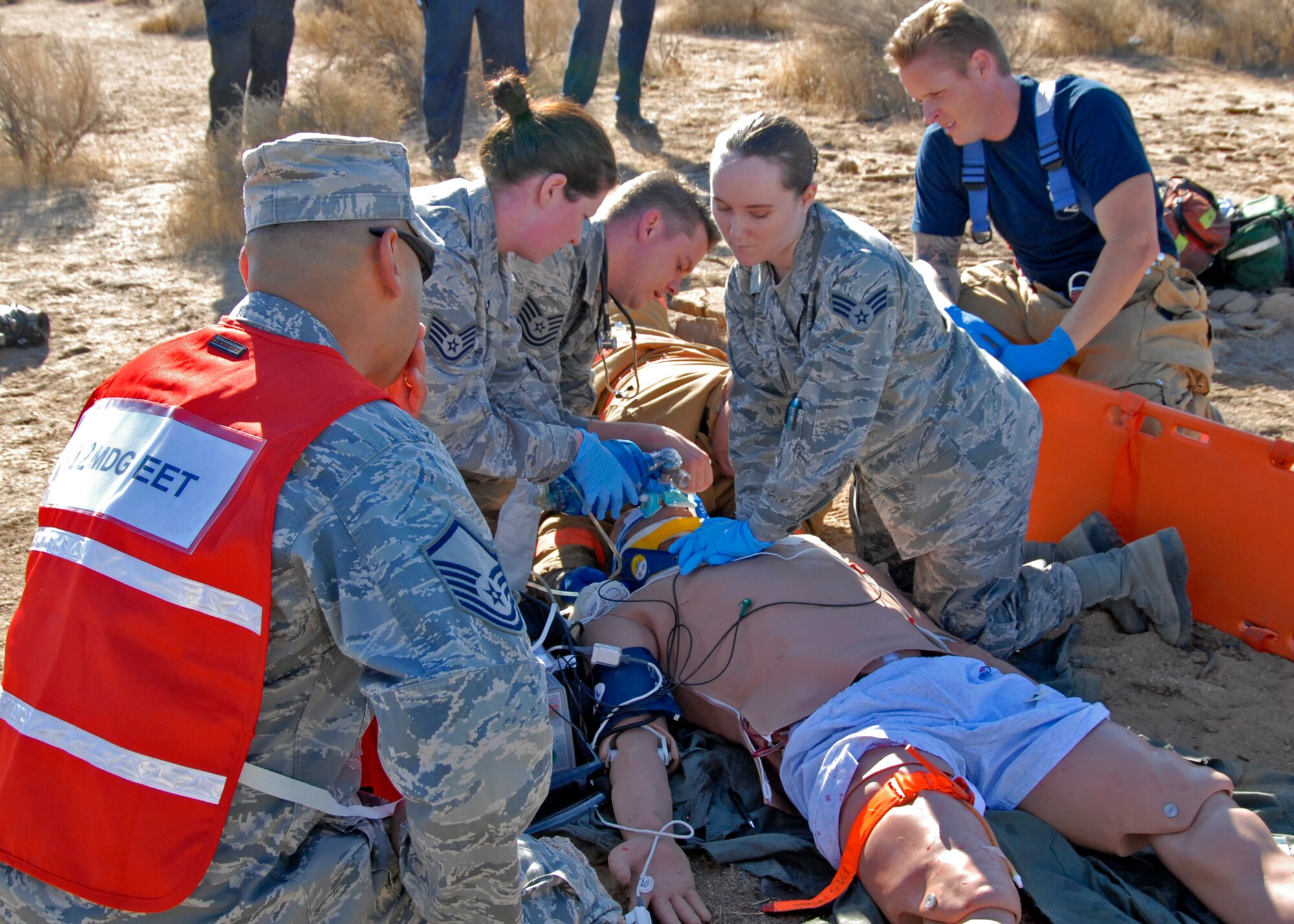 First responders demonstrate their emergency response capabilities during the Desert Wind 13-01 exercise, which tested Edwards' response to a major aircraft incident Oct. 1. Medical personnel trained for the first time using a METIman mannequin, adding a new dimension of realism to the exercise, better preparing them for real-world scenerios. (U.S. Air Force Photo by Laura Mowry)