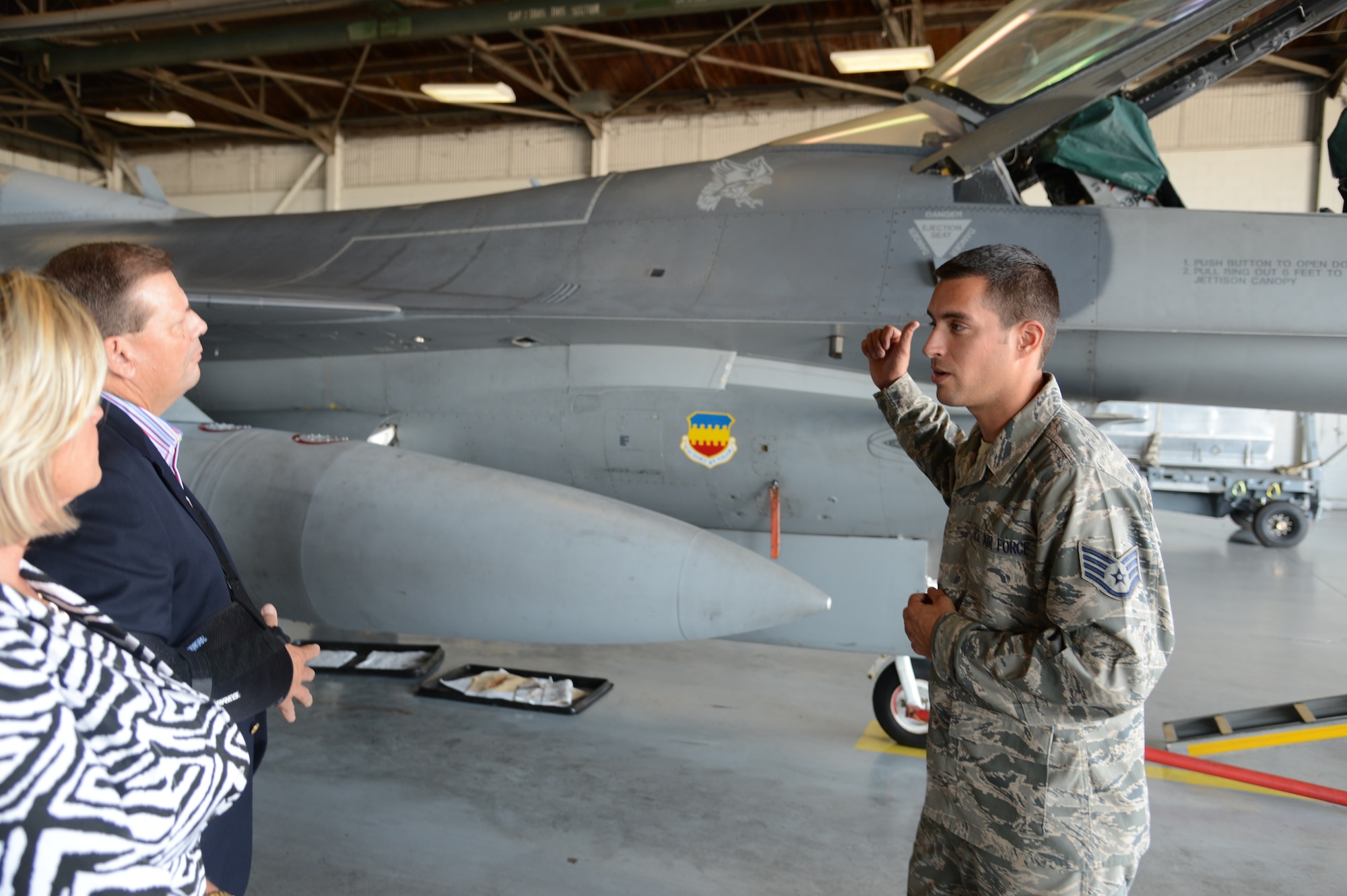 Hampton Caughman and his wife Jane listen to a brief about the F-16 Fighting Falcon during a visit to the load barn here at Shaw Air Force Base, S.C. on Sept. 25, 2012. Six Gold Star families were treated to lunch and honored with a presentation about their family members that were lost during a deployment or combat situation. They were the guests of 9th Air Force Commander, U.S. Air Force Maj. Gen. Lawrence Wells, who presented each family a plaque with the a Gold Star on it.
(U.S.  Air Force photo by Master Sgt. Cohen A. Young/Released)
