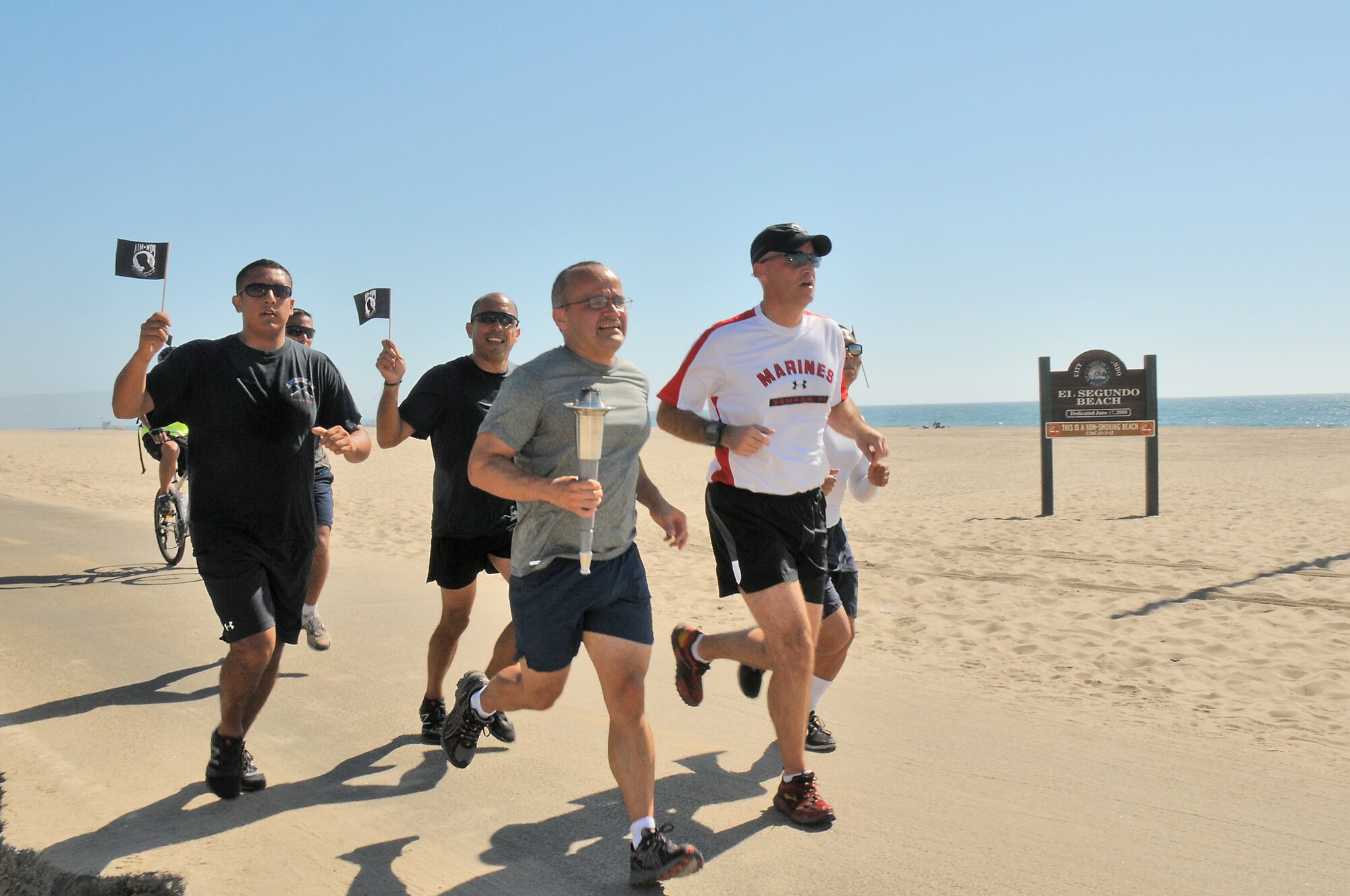 Runners nearing the end of the POW-MIA relay pass by El Segundo Beach, Sept. 20. The relay began on Terminal Island at the Coast Guard base, crossed the Vincent Thomas Bridge and ended at Los Angeles AFB. (Photo by Joe Juarez)
