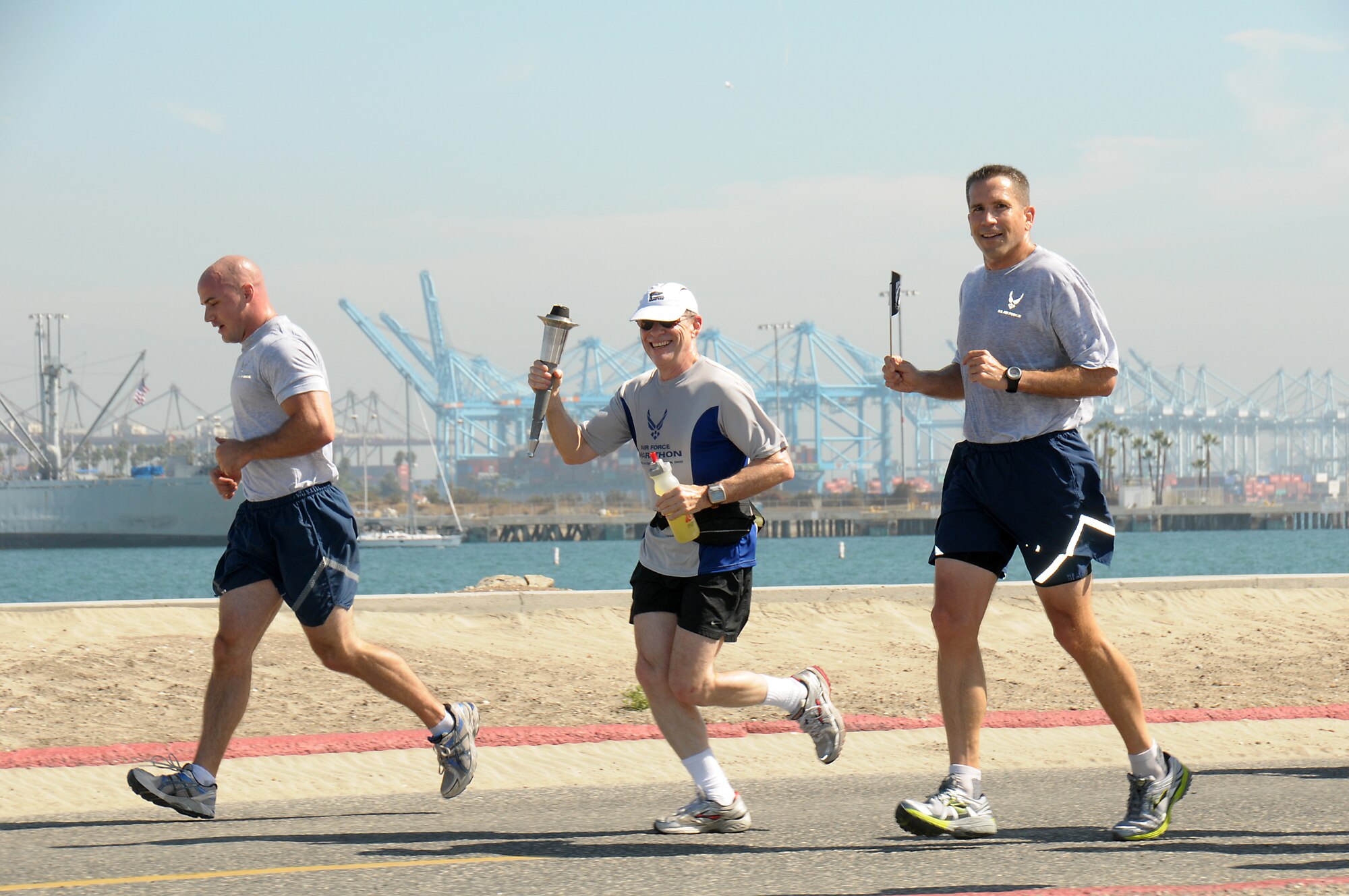 Douglas Loverro, SMC executive director, carries the torch on the relay leg through San Pedro during POW-MIA Day torch run, Sept. 20.  (Photo by Joe Juarez)