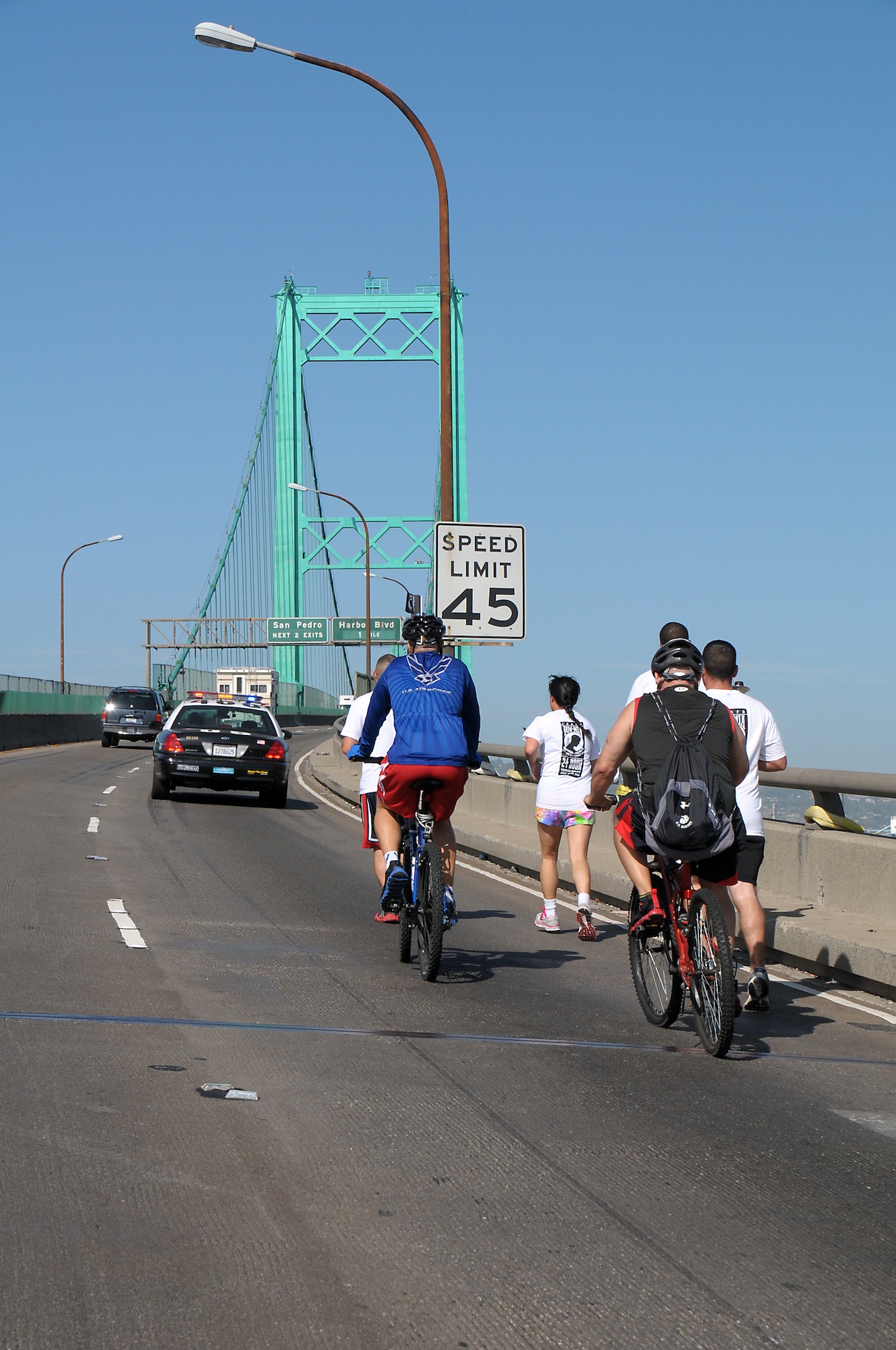 Runners carry the torch across the Vincent Thomas Bridge during the POW-MIA Day torch run, Sept. 20.  (Photo by Joe Juarez)