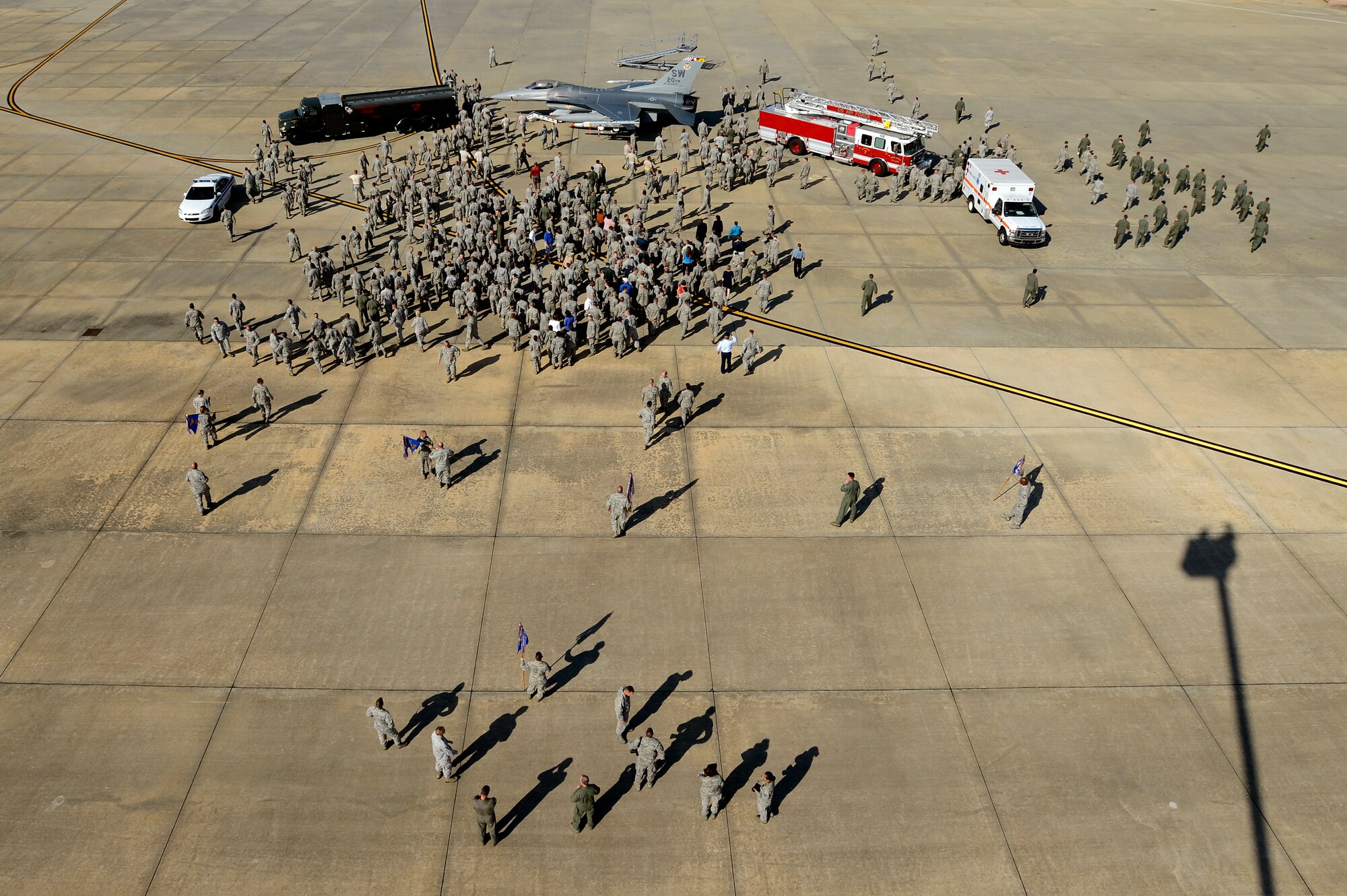 Airmen and civilians fall out of formation after taking a 20th Fighter Wing group photo, Sept. 27, 2012, Shaw Air Force Base, S.C. More than 400 Airmen and civilians from each group assigned to the 20th FW assembled on the flightline to help document history. Every few years a group photo of the entire fighter wing is taken to keep for historical documentation. (U.S. Air Force photo by Staff Sgt. Kenny Holston/Released)