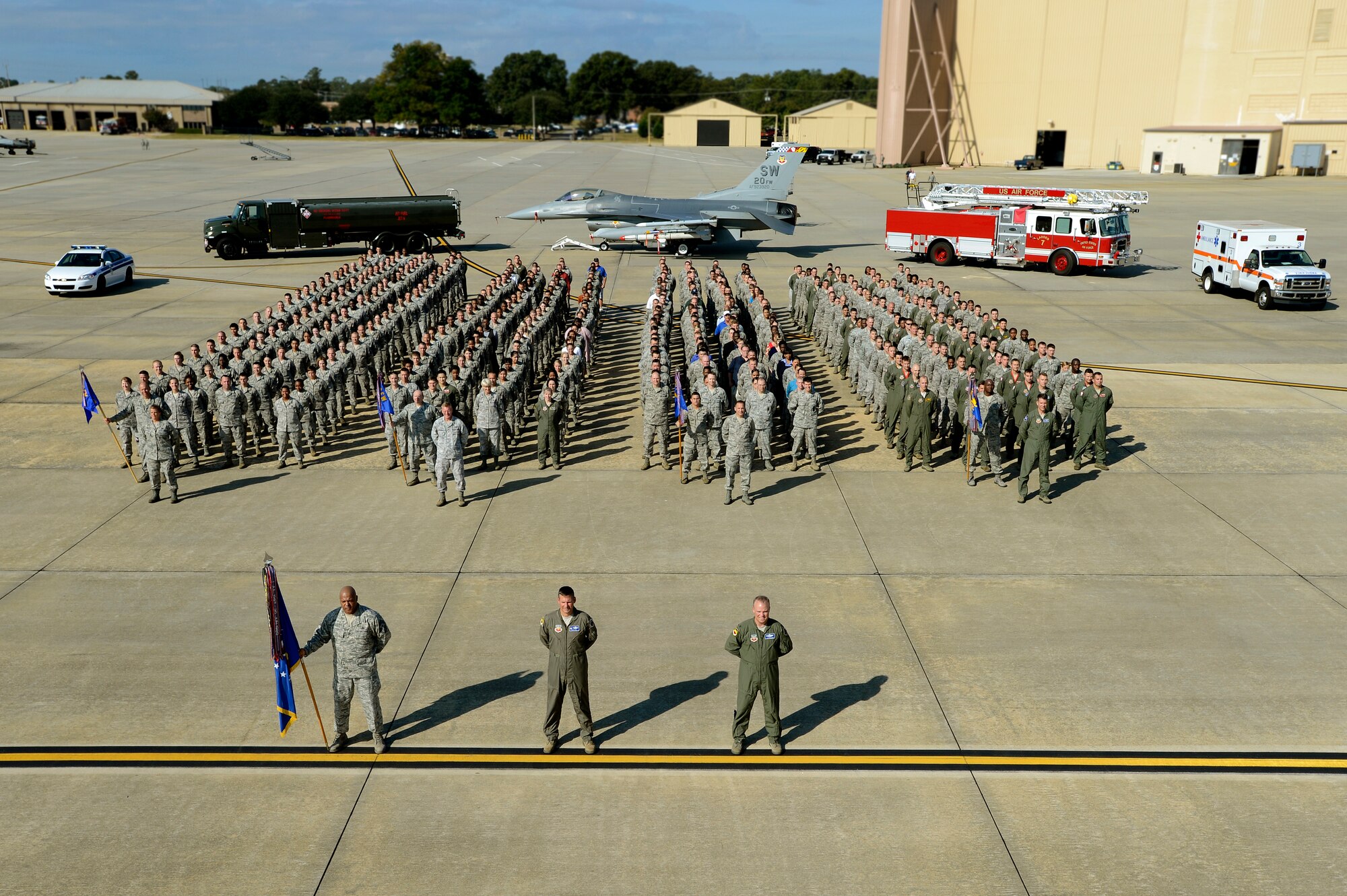 More than 400 Airmen and civilian contractors assigned to the 20th Fighter Wing stand in formation for a group photo, Sept. 27, 2012, Shaw Air Force Base, S.C. Airmen and civilians from each group assigned to the 20th FW assembled on the flightline to help document history. Every few years a group photo of the entire fighter wing is taken to keep for historical documentation. (U.S. Air Force photo by Staff Sgt. Kenny Holston/Released)