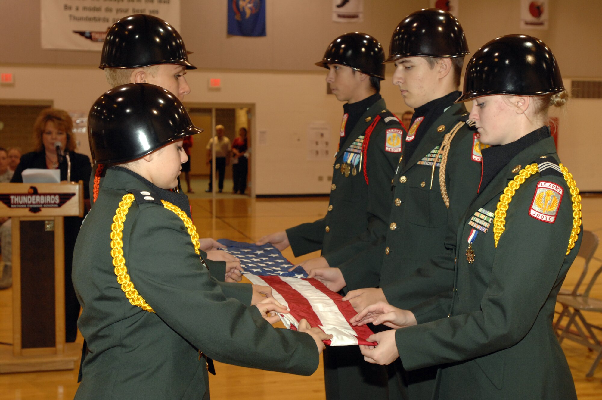 Grand Forks Public School District Army Junior ROTC cadets perform a flag folding ceremony Oct. 1, 2012, at Nathan Twining Elementary and Middle School here. Students, faculty, senior leaders from the base and community leaders gathered there to celebrate the school’s 50th anniversary. (U.S. Air Force photo/Senior Airman Susan L. Davis)
