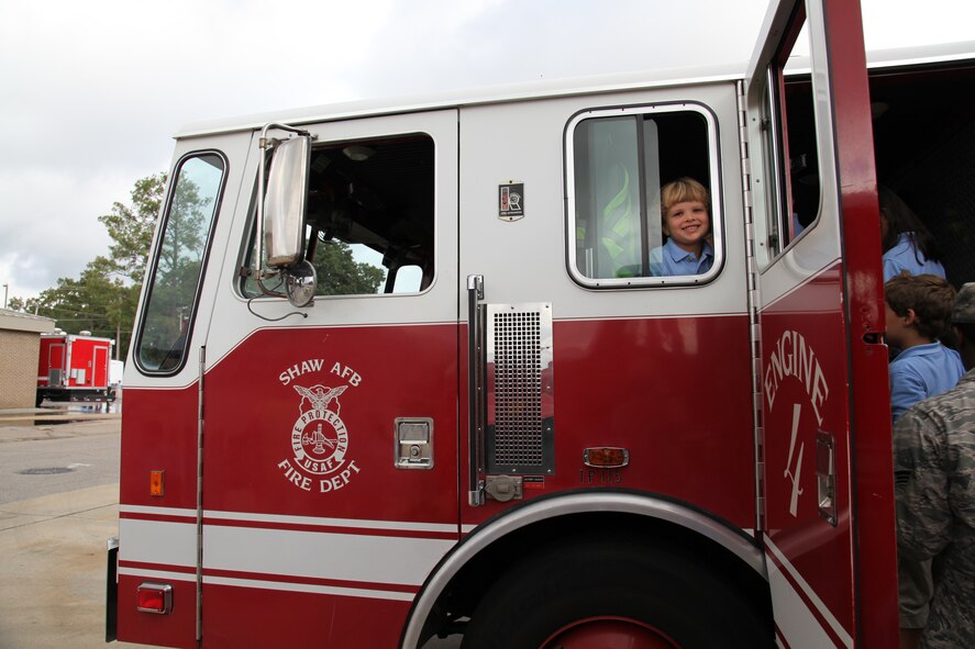 Andrew Segars, Wilson Hall student, takes ove the back seat of Engine 4 at the base fire station. The Shaw Air Force Base fire department welcomed 60 Wilson Hall kindergartners for a tour Oct. 2, 2012.  (U.S. Air Force photo by 1st Lt. Ann Blodzinski/Released)