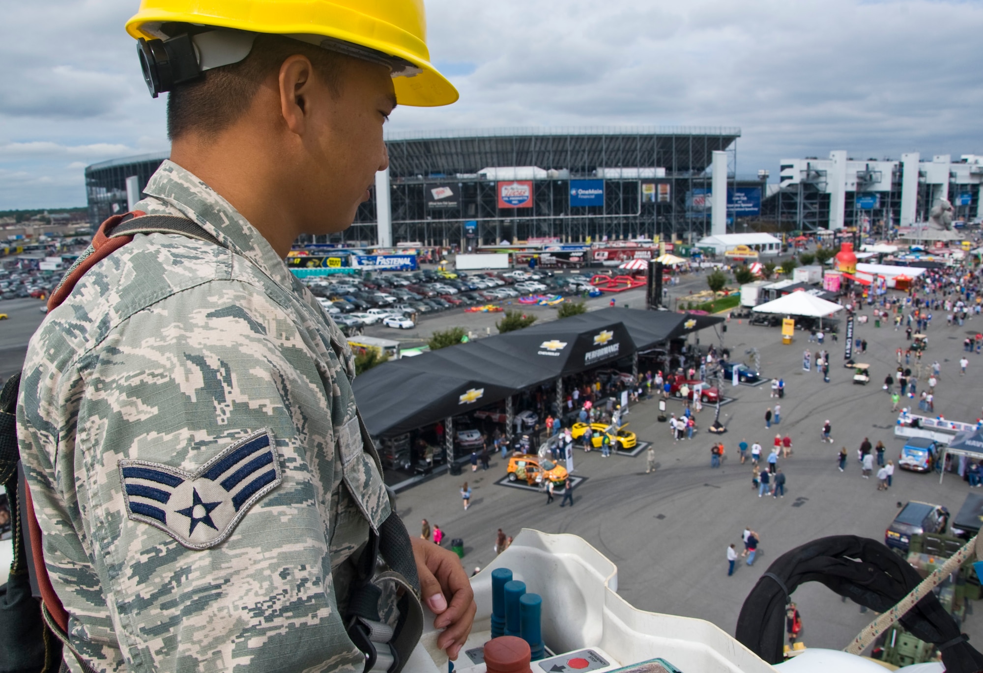 Senior Airman Allan Flores, a member of the 436th Civil Engineer Squadron electrical shop, observes the Monster Fun Zone from a bucket truck Sept. 29, 2012, at Dover International Speedway in Dover, Del. Team Dover members interacted with race fans during the pre-race events. (U.S. Air Force photo by Airman 1st Class Samuel Taylor)