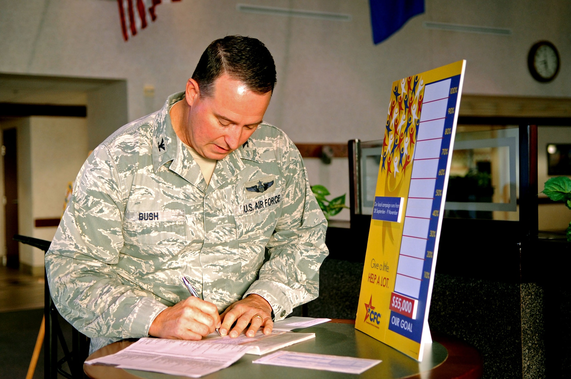 Col. Tim Bush, 319th Air Base Wing commander, signs his pledge for the Combined Federal Campaign during the CFC kick-off ceremony, which took place Sept. 28, 2012, at the Airey Dining Facility on Grand Forks Air Force Base, N.D. The CFC is the world’s largest annual workplace charity campaign. Its mission is to promote and support philanthropy through a program that is employee-focused, cost-efficient, and effective in providing all federal employees the opportunity to improve the quality of life for all. (U.S. Air Force photo/Staff Sgt. Amanda N. Grabiec)