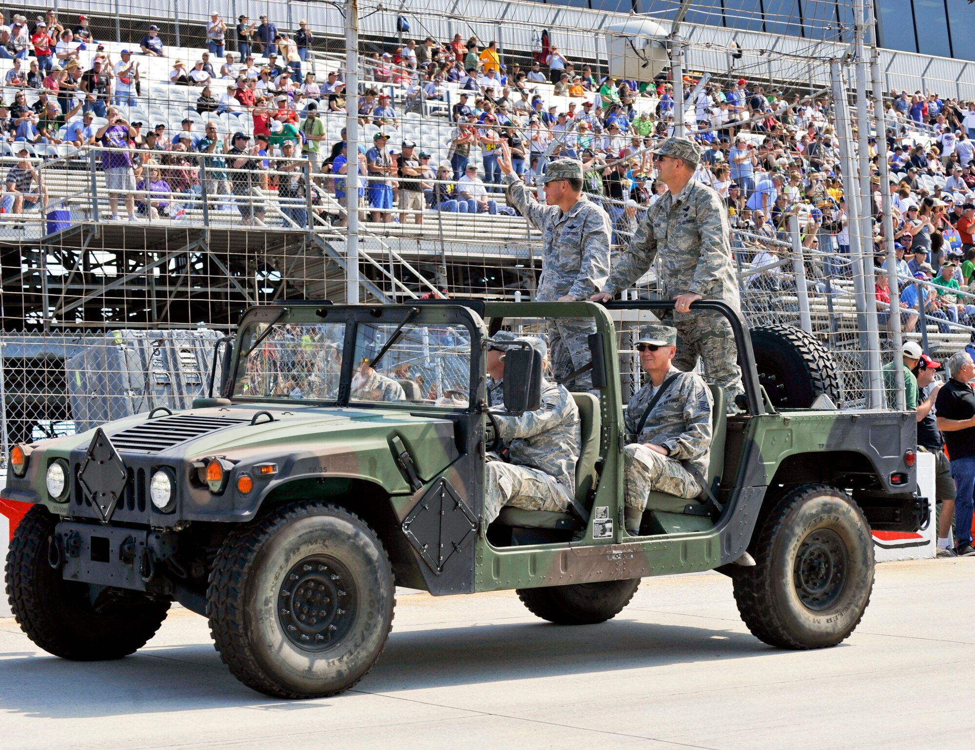 Dover Air Force Base, Del., leadership wave to the crowd during a parade lap Sept. 29, 2012, at Dover International Speedway in Dover, Del. Team Dover members interacted with race fans during the pre-race events. (U.S. Air Force photo by Airman 1st Class Samuel Taylor)