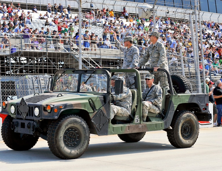 Dover Air Force Base, Del., leadership wave to the crowd during a parade lap Sept. 29, 2012, at Dover International Speedway in Dover, Del. Team Dover members interacted with race fans during the pre-race events. (U.S. Air Force photo by Airman 1st Class Samuel Taylor)