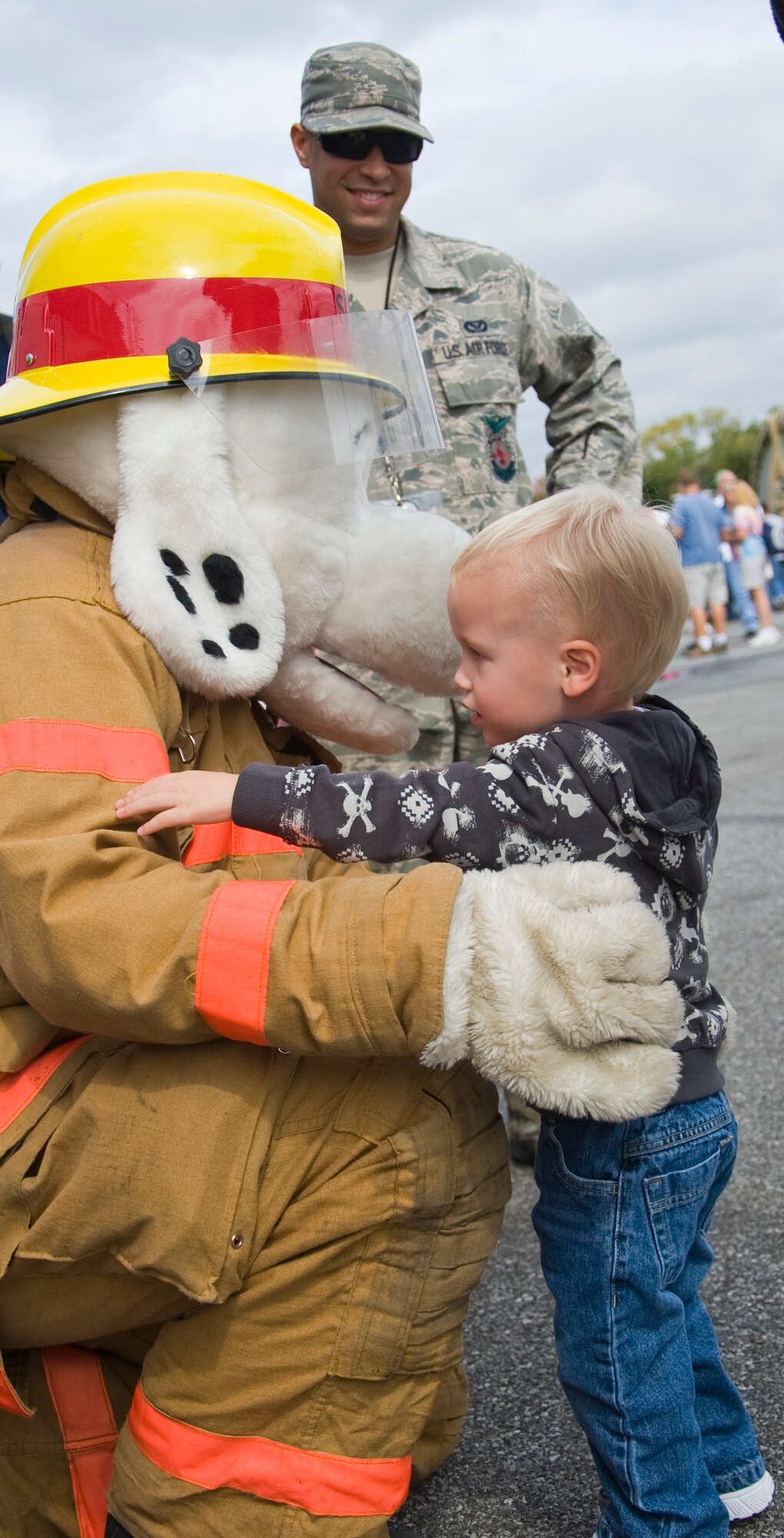 Gavin Canterbury hugs Team Dover’s fire dog Sparky Sept. 29, 2012, at the Monster Fun Zone at Dover International Speedway in Dover, Del. Team Dover members interacted with race fans during the pre-race events. (U.S. Air Force photo by Airman 1st Class Samuel Taylor) 