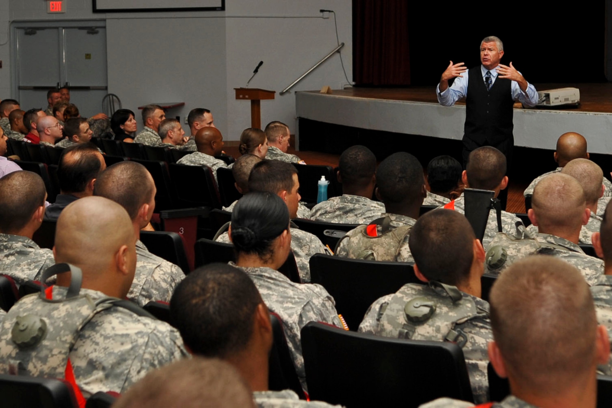 Bob Delaney, standing, a former National Basketball Association referee who suffered from post-traumatic stress disorder during his time as a New Jersey state trooper, speaks to a packed house at Jacobs Theater during the Army-wide Suicide Prevention Awareness Stand-Down Day events at Fort Eustis, Va., Sept. 27, 2012. Delaney detailed his gritty undercover assignment infiltrating the Mafia, how the experience left lasting psychological effects on him long after he retired his badge, and how his experiences compare to that of Soldiers returning from combat in Iraq and Afghanistan. (U.S. Air Force photo by Staff Sgt. Wesley Farnsworth/Released)