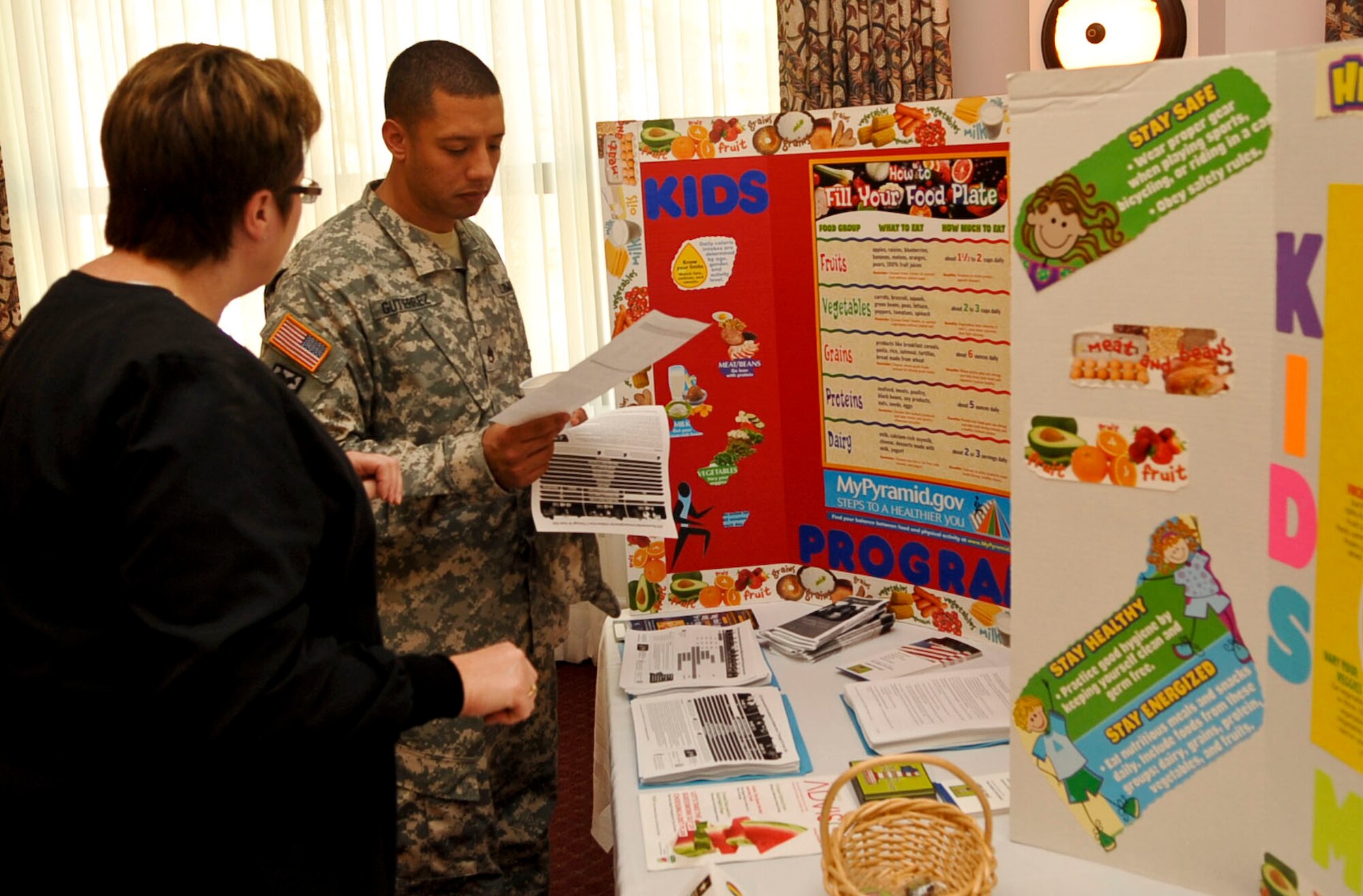 U.S. Army Staff Sgt. Jose Gutierrez, right, 244th Quartermaster Battalion Advanced Individual Training platoon sergeant, speaks with Sheila Pankoke, the head nurse at McDonald Army Health Center's pediatrics clinic, at the Fort Eustis Club's Comprehensive Resilience Fair at Fort Eustis, Va., Sept. 27, 2012. Professionals from more than 30 support agencies were available to assist Soldiers and families in need as part of the installation's activities for the Suicide Prevention Stand-Down Day. (U.S. Air Force photo by Staff Sgt. Wesley Farnsworth/Released)
