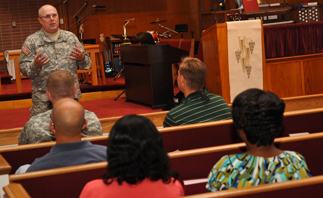 U.S. Army Chap. (Maj.) Scott Daniel, 633rd Air Base Wing family life chaplain, speaks to guests in attendance at a post-traumatic stress and suicide prevention briefing at the Regimental Memorial Chapel at Fort Eustis, Va., Sept. 27, 2012. The briefing was one of several events held in support of the Army-wide Suicide Prevention Stand-Down Day, which saw Army installations across the nation pause regular operations to focus on Soldier and family resilience, and comprehensive health. (U.S. Air Force photo by Staff Sgt. Wesley Farnsworth/Released)