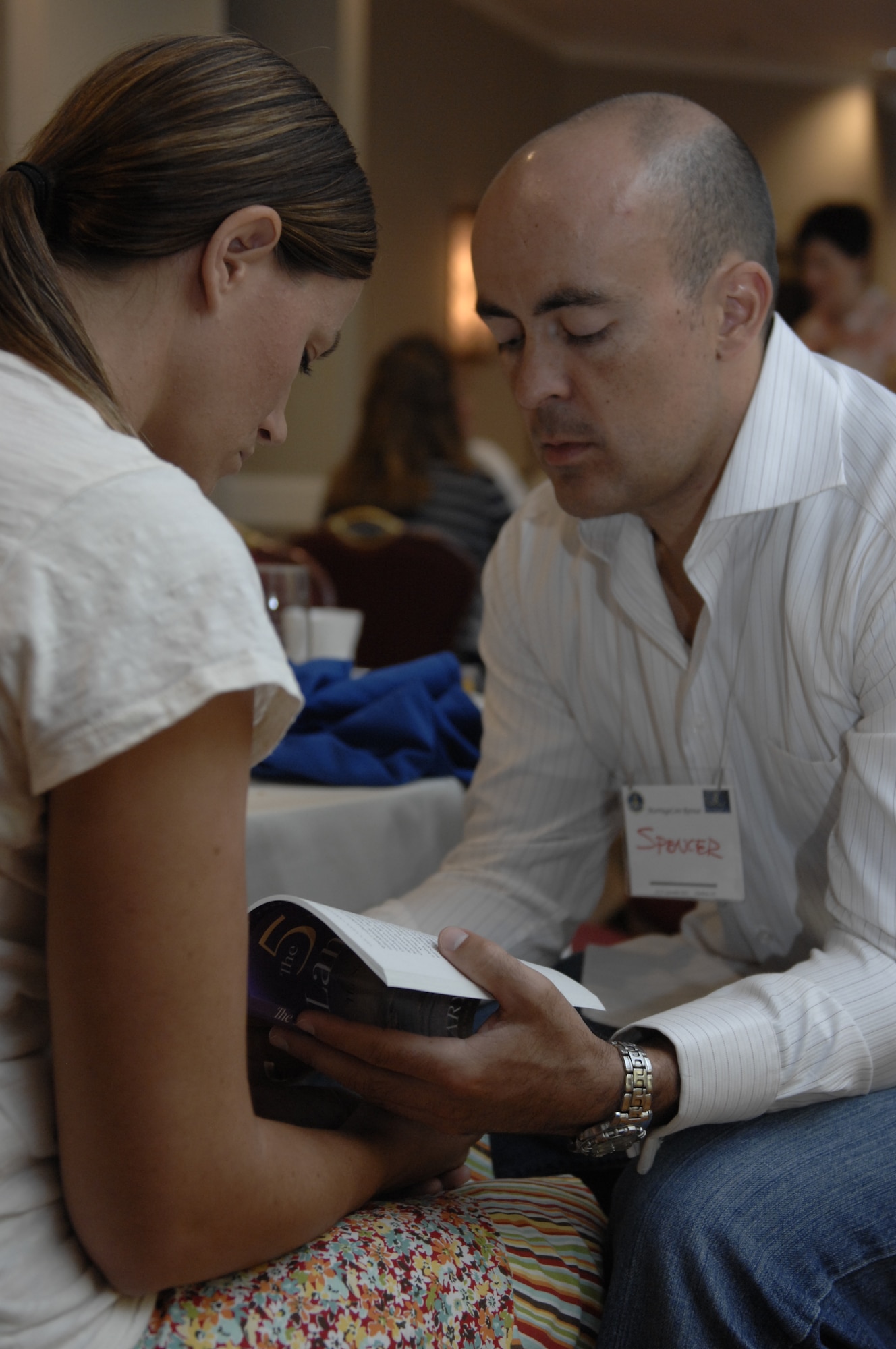 Capt. Spencer Crandall, currently assigned to U.S. Air Forces Central, and his wife Kristen review a book, called "The 5 Love Languages of Love" by Gary Chapman, together during a marriage retreat in Charlotte, N.C., Sept. 23, 2012. The book was a gift to the participants of the retreat and was meant to help them understand the different ways people express love. (U.S. Air Force photo by Airman 1st Class Krystal M. Jeffers/Released)
