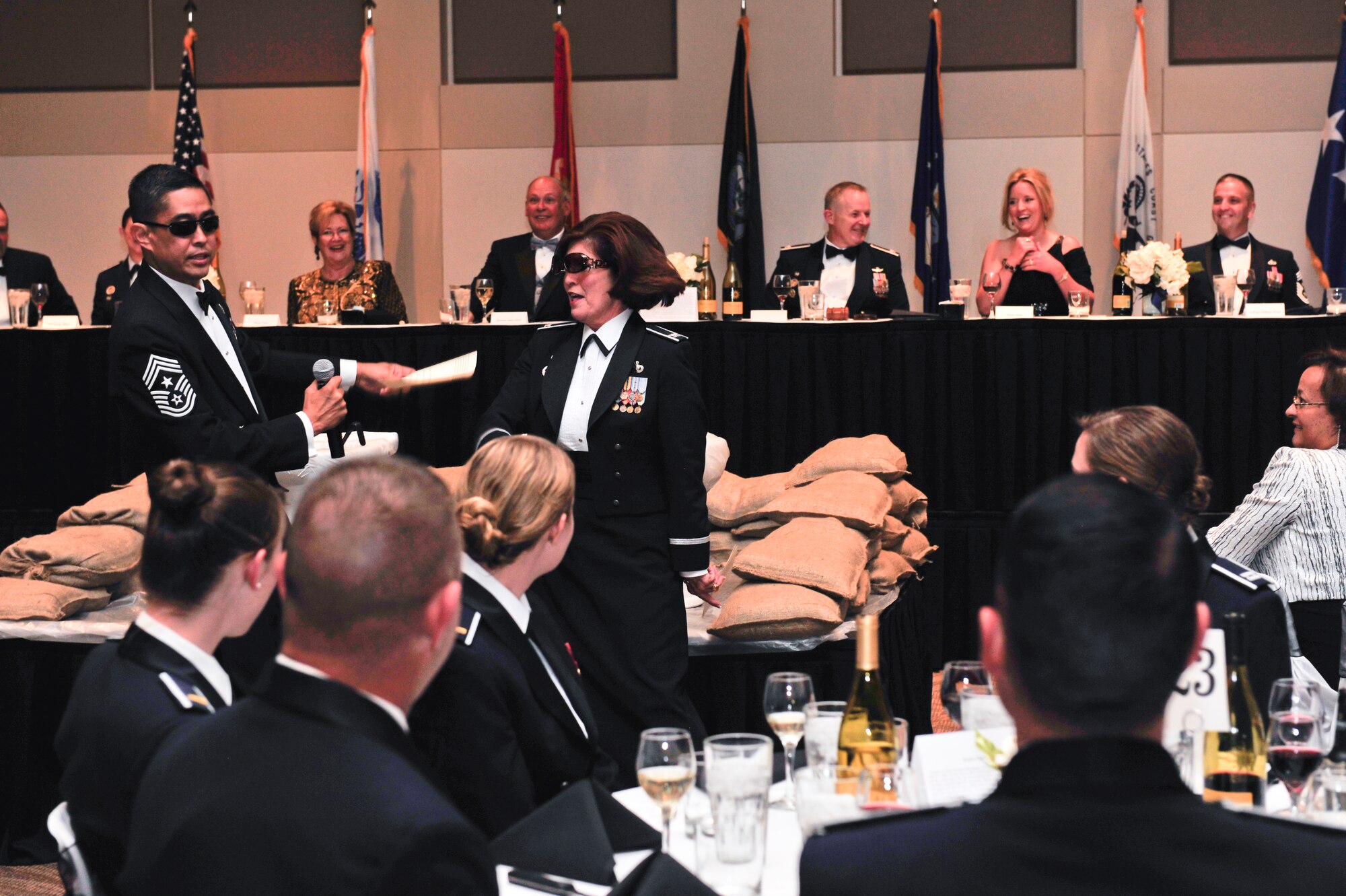 BUCKLEY AIR FORCE BASE, Colo. – Chief Master Sgt. Brian Wong, Air Reserve Personnel Center command chief, and Col. Patricia Blassie, ARPC commander, don sunglasses and perform a rap routine to entertain the audience during a dining out Sept. 28, 2012, at the Leadership Development Center. Rather than present the traditional Air Force ball, Col. Daniel Dant, 460th Space Wing commander, offered Team Buckley a different experience to celebrate the Air Force’s 65th birthday. (U.S. Air Force photo by Airman 1st Class Darryl Bolden Jr.)