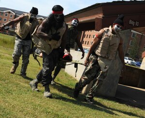 Members of team "Dead Precident” perform a litter carry as part of an expeditionary fitness challenge at Eagle Park, Langley Air Force Base, Va., Sept. 28, 2012. The 633rd Communications Squadron hosted the challenge to celebrate the end of a 90-day weight loss program. (U.S. Air Force photo by Airman 1st Class Teresa Aber/Released)