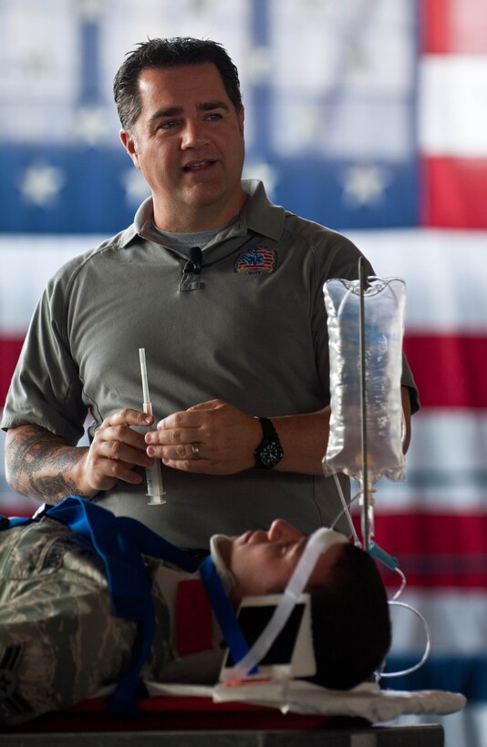 Joe McCluan, assistant director of the Stay Alive from Education program, explains paramedic procedures in a simulated emergency scenario to, Airman 1st Class Spencer Butler, 28th Operations Support Squadron communications technician, during a “Street Smart” presentation in the Pride Hangar on Ellsworth Air Force Base, S.D., Sept. 27, 2012. The program explained the dangers of unsafe driving habits, drinking and driving and the extreme consequences of poor decision making. (U.S. Air Force photo by Airman 1st Class Zachary Hada/Released)