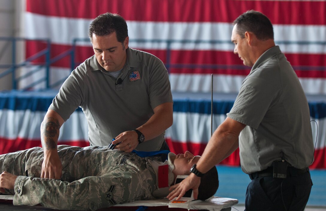 Joe McCluan, and Scott Neusch of the Stay Alive from Education program, demonstrates simulated paramedic procedures on a volunteer, Airman 1st Class Spencer Butler, 28th Operations Support Squadron communications technician, during a “Street Smart”, Safety Day presentation at Ellsworth Air Force Base, S.D., Sept. 27, 2012. The presentation was implemented to educate individuals on the dangers of unsafe driving. (U.S. Air Force photo by Airman 1st Class Zachary Hada/Released)