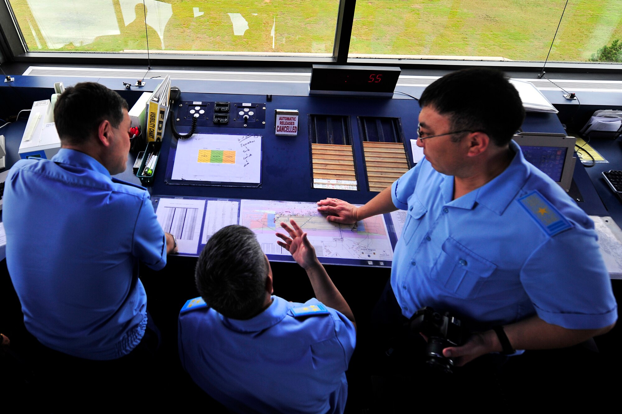 Members of the Kazakhstan Air Defense Forces discuss flight safety operations while viewing the inner workings of the Shaw flight tower, Sept. 19, 2012, Shaw Air Force Base, S.C. The Kazakhstan ADF visited Shaw for two days to learn about the 20th Fighter Wing’s safety programs and how they work. (U.S. Air Force photo by Staff Sgt. Kenny Holston/Released) 