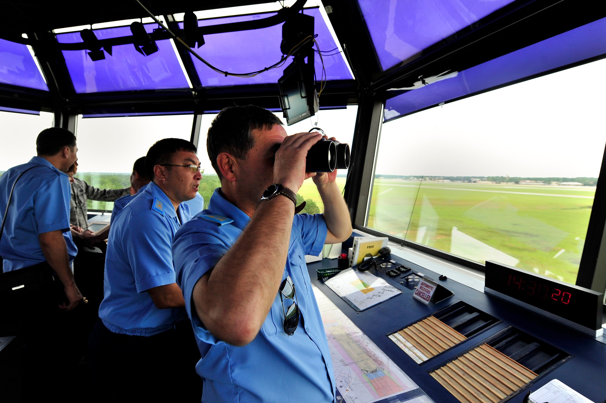 Members of the Kazakhstan Air Defense Forces look across the Shaw flightline from the flight tower, Sept. 19, 2012, Shaw Air Force Base, S.C. The Kazakhstan ADF visited Shaw for two days to learn about the 20th Fighter Wing’s safety programs and how they work. (U.S. Air Force photo by Staff Sgt. Kenny Holston/Released)