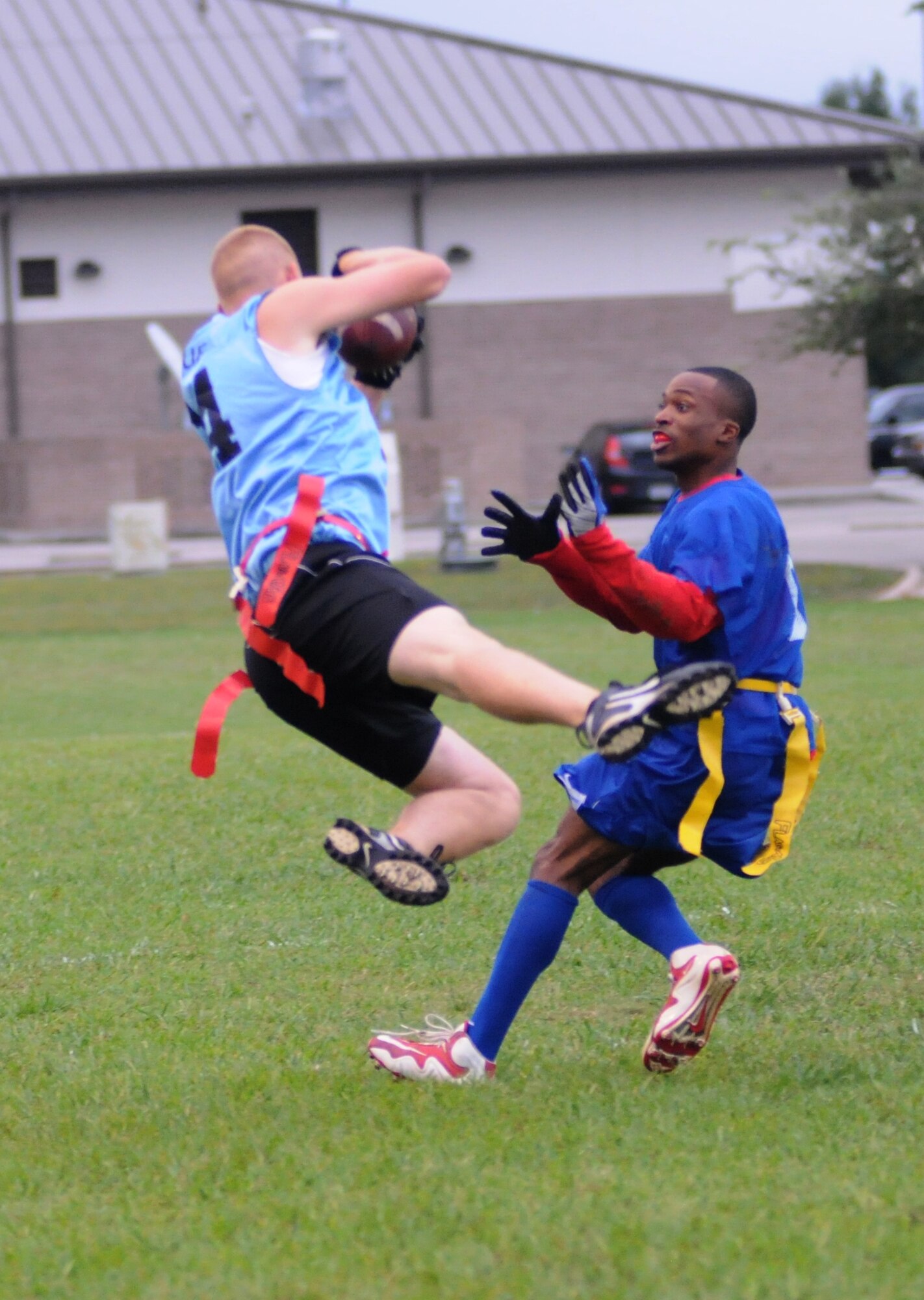 Andrew Wieting, 338th Training Squadron, falls to the ground after catching a pass while Trae Clark, 334th Training Squadron, plays defense during an intramural flag football game Oct. 1, 2012, at Keesler Air Force Base, Miss.  (U.S. Air Force photo by Kemberly Groue)
